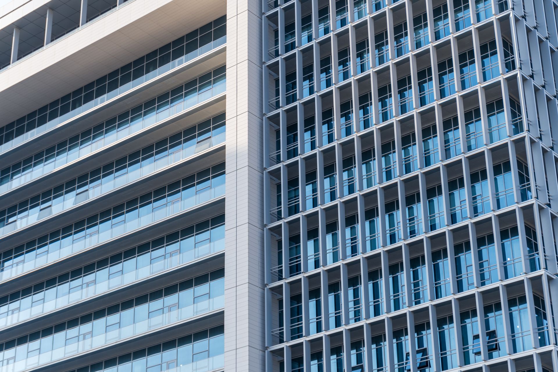 Modern building facade with glass windows and geometric balconies